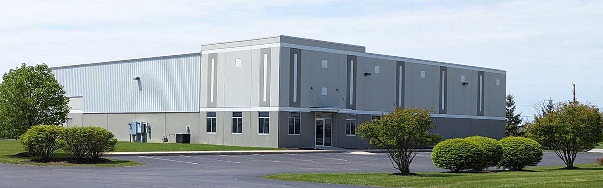 Gray and white pre-engineered metal building for light industrial and manufacturing use